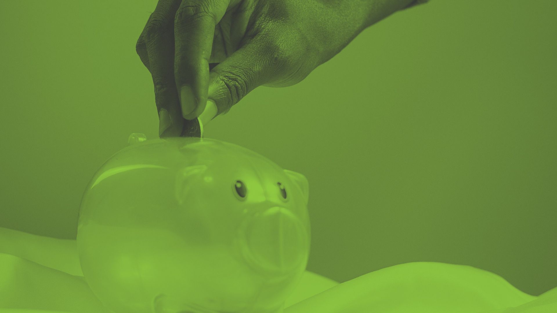 An image of a child putting money into a piggy bank