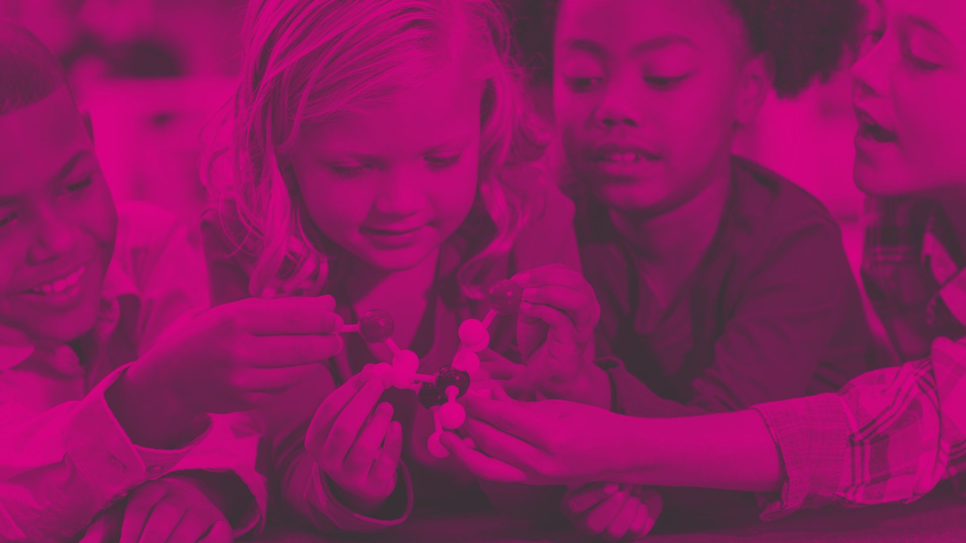 A photograph of a group of primary age children playing with a chemistry model in an educational setting - Opportunities for Oval Learning schools to apply for Primary Science Teaching funding