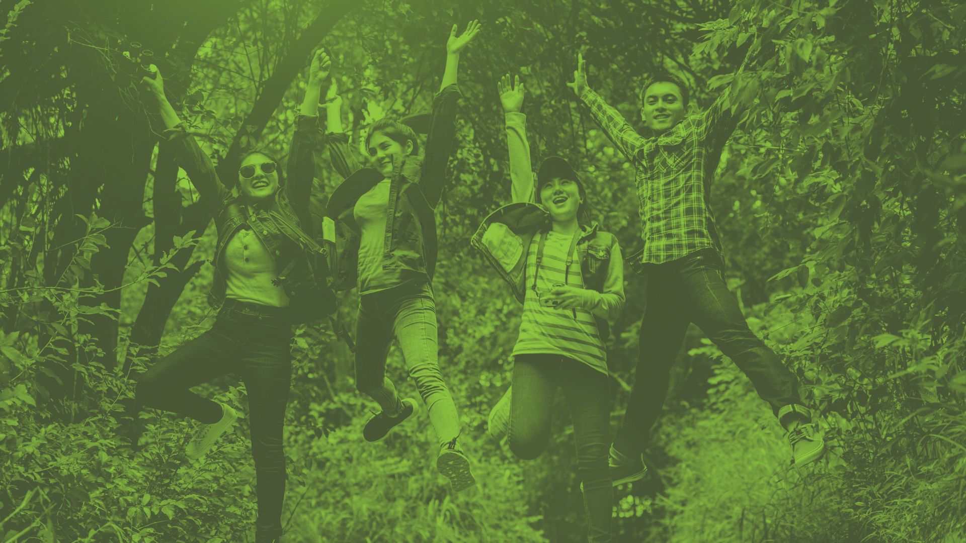 A photograph of young people jumping up with excitement in a wooded area - Opportunities for young people at Oval Learning schools to get funding for travel and adventures