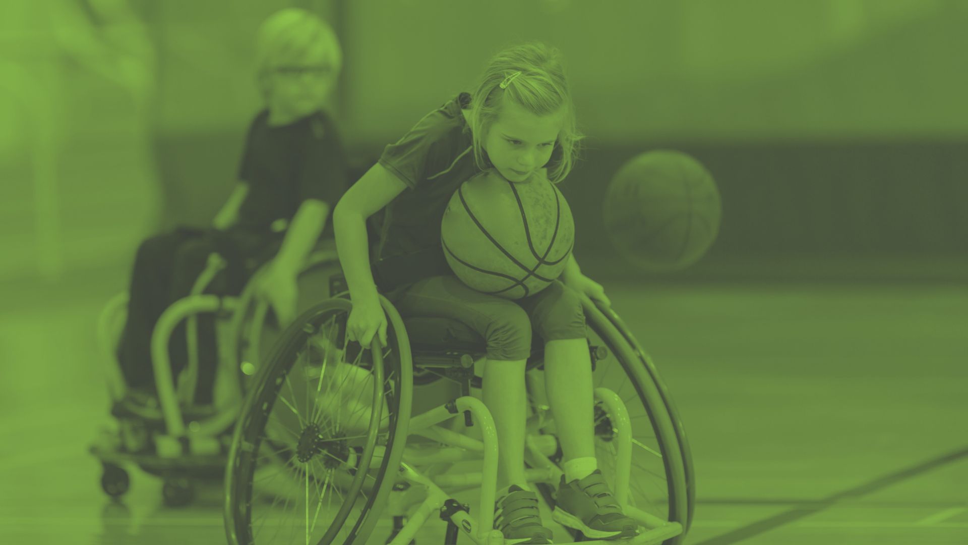 Photo of children using wheelchairs and playing basketball - Opportunities for young people at Oval Learning schools to get funding to support them in education and sports