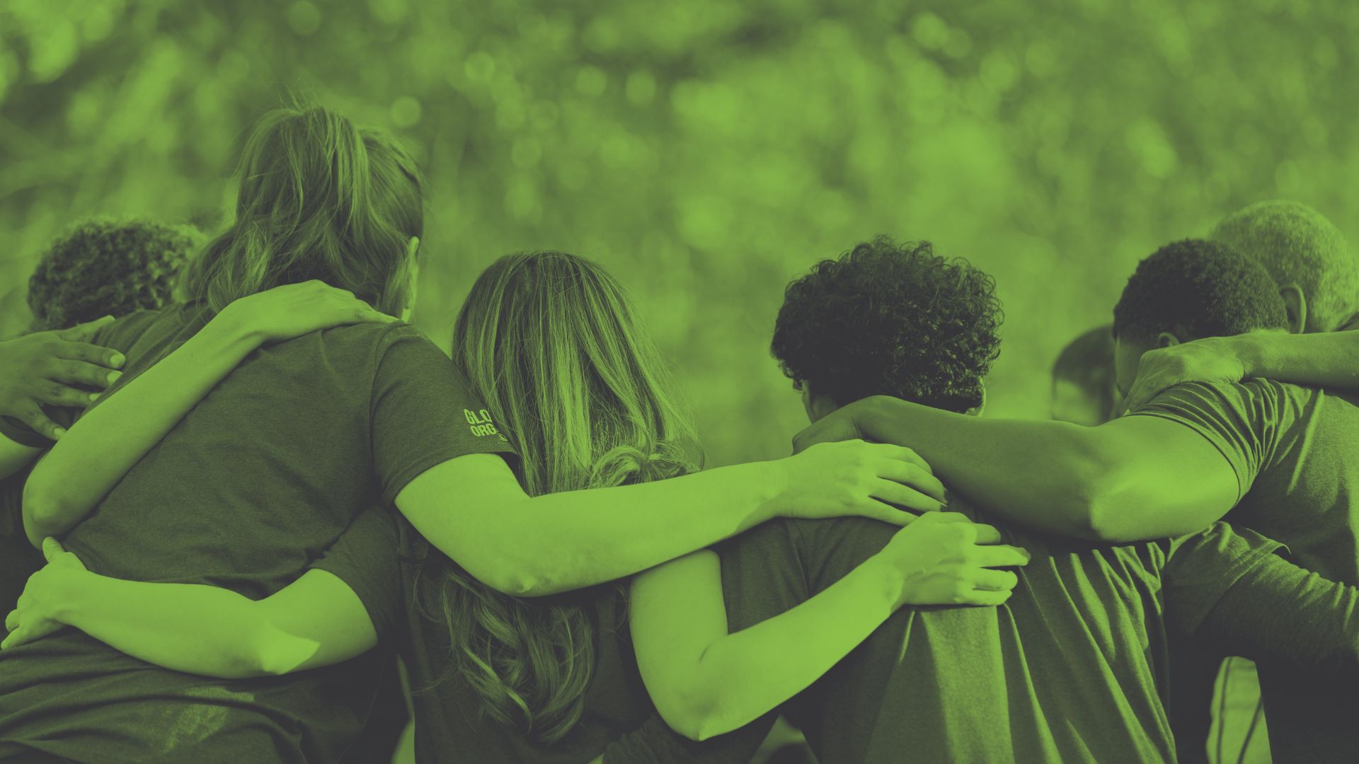 Photo of a group of people linking arms in a show of community