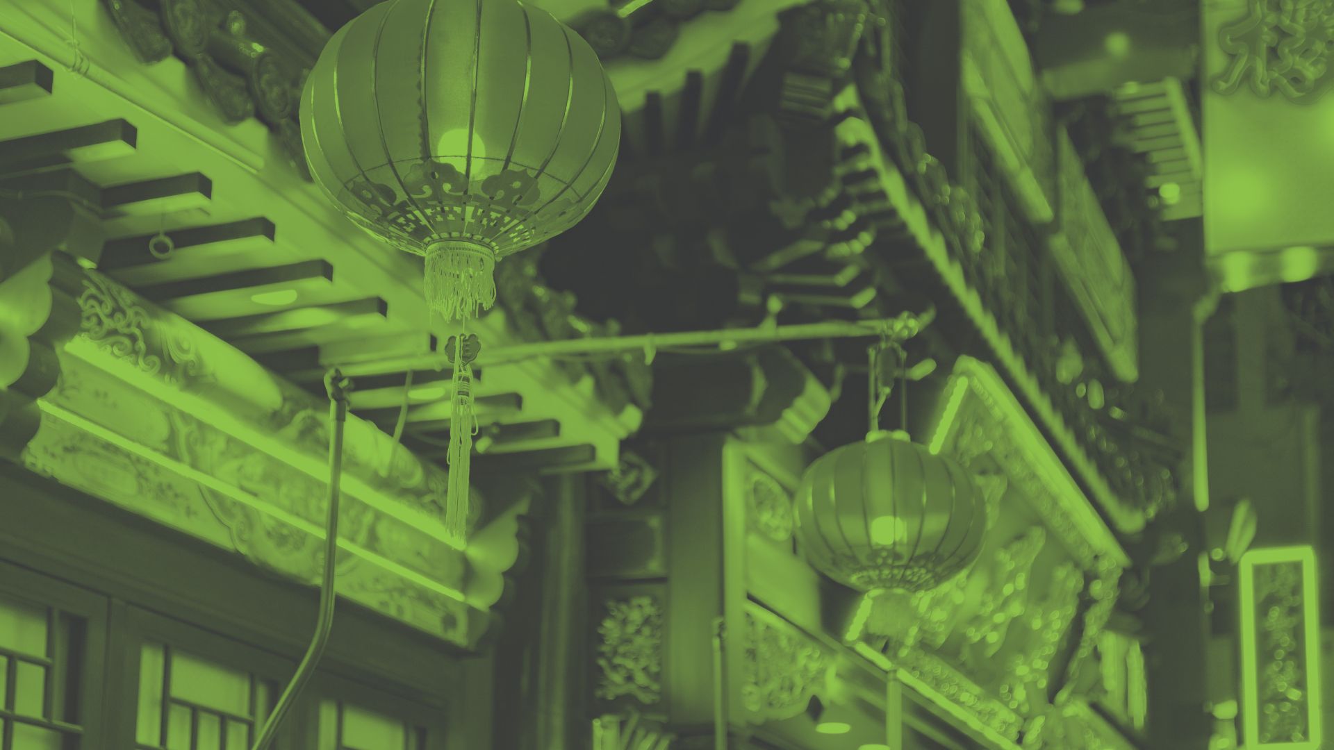 Photo of Japanese lanterns hanging from buildings in a city street